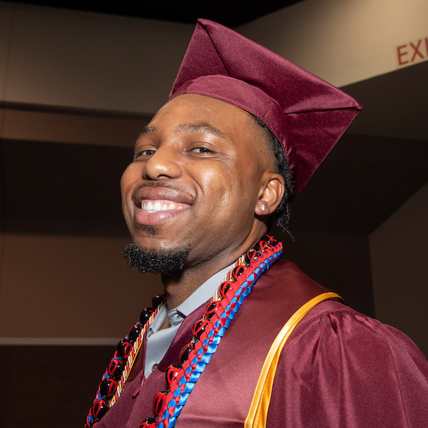 young man in grad cap and gown 