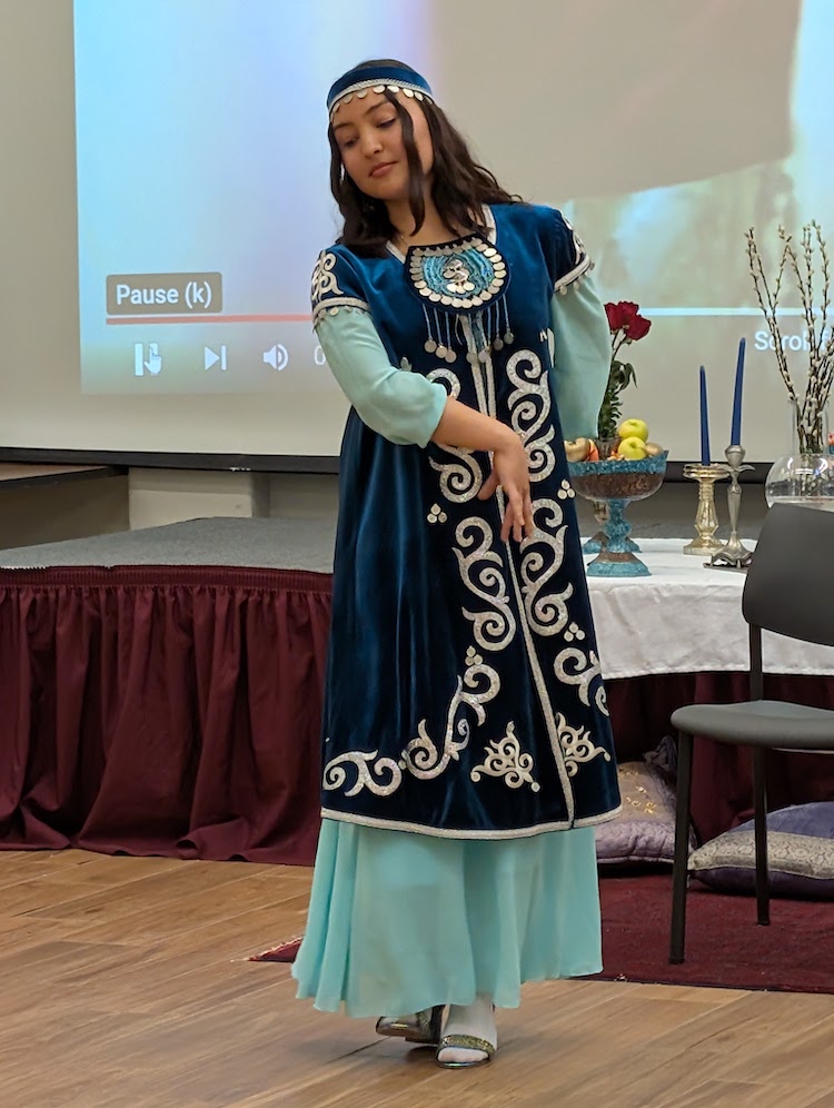 young woman in traditional blue dress dancing