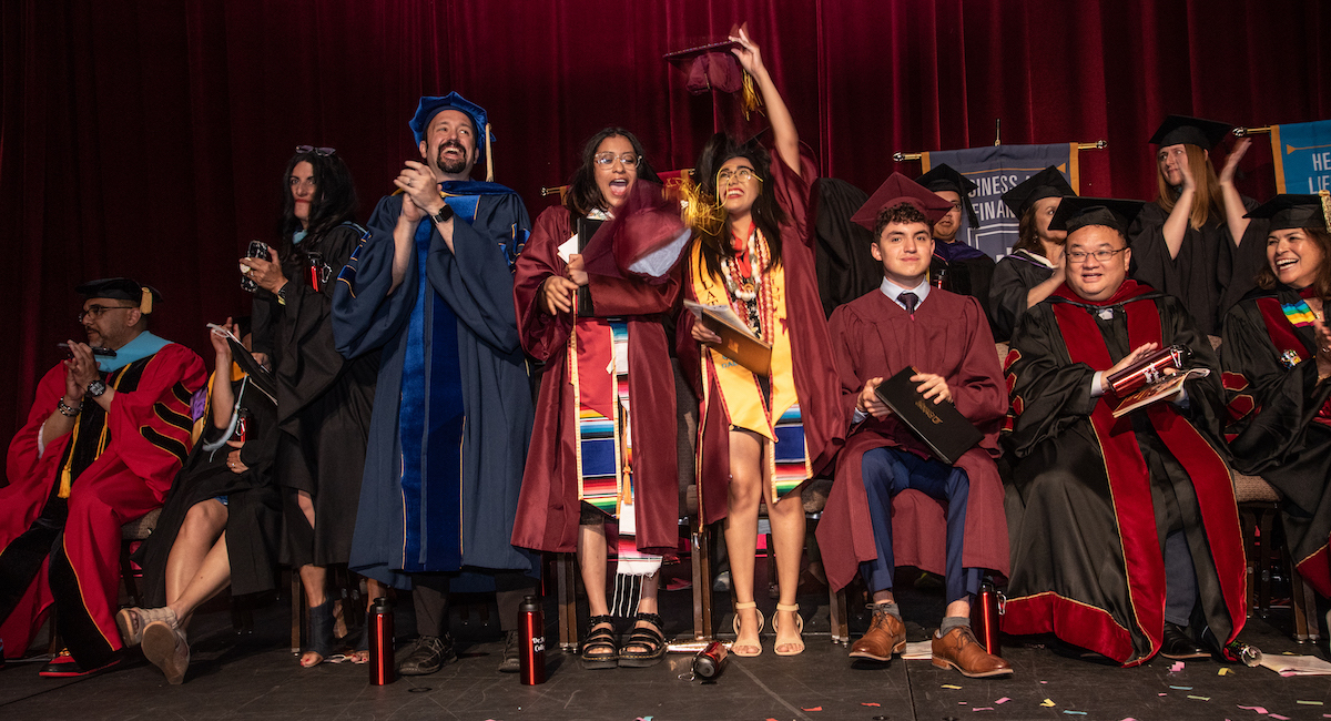 students cheering at graduation