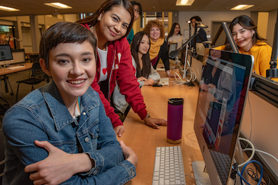 two young women looking at computer monitor