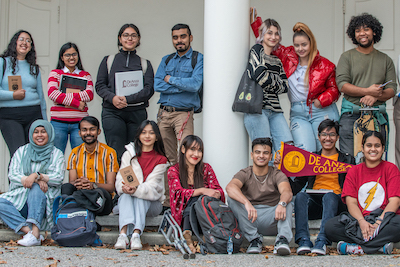 diverse group of students in front of building with white columns