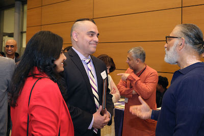 President Torres speaking with several people at benefit dinner