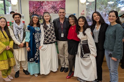 President Torres with students in traditional costumes at Nowruz event
