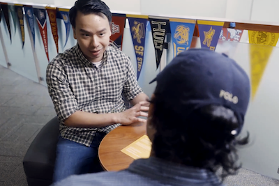 youthful counselor speaking to student