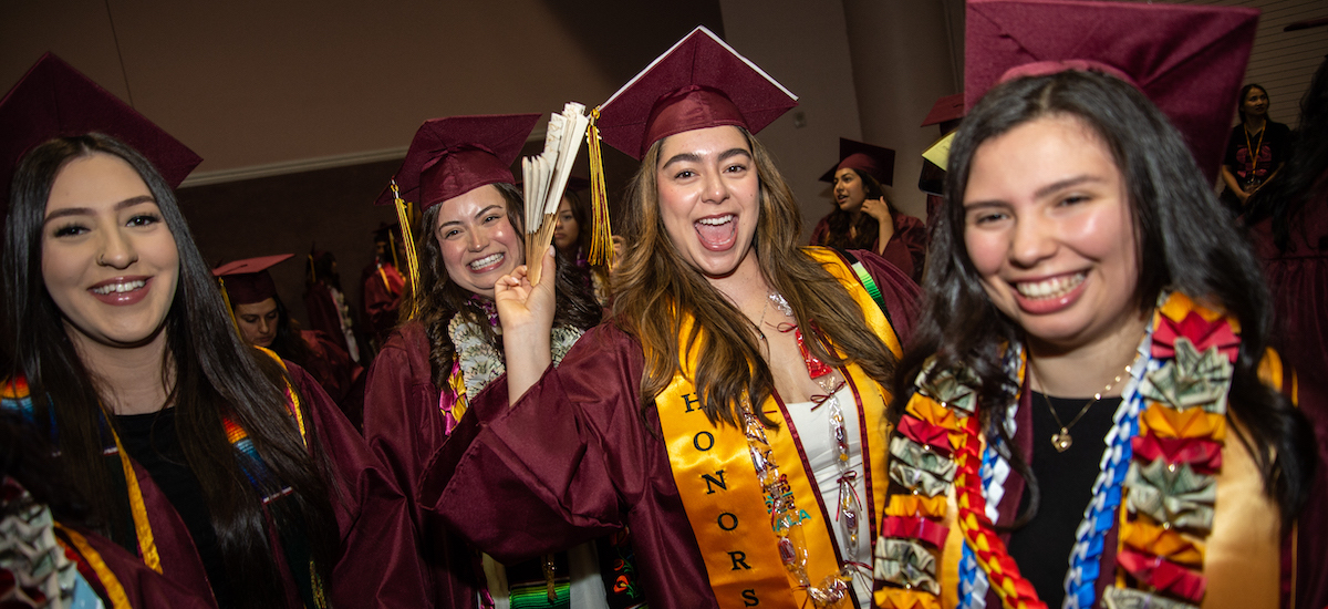 grads waving and celebrating